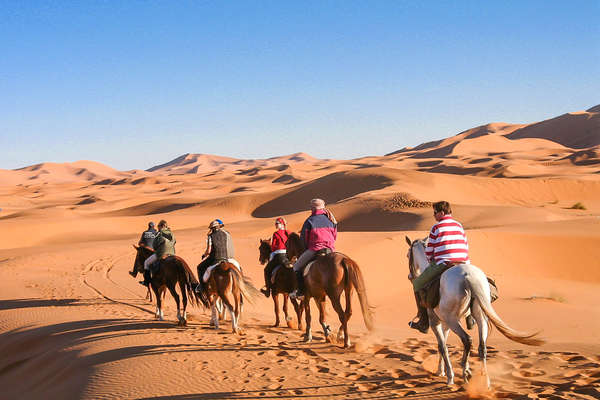 Cavaliers à cheval dans le désert marocain